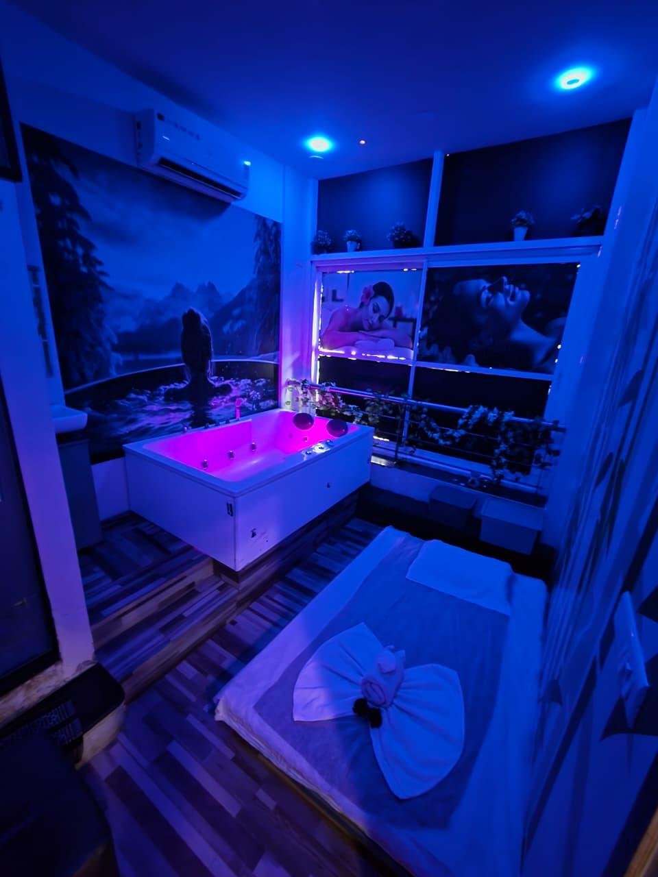 Jacuzzi room with blue mood lighting