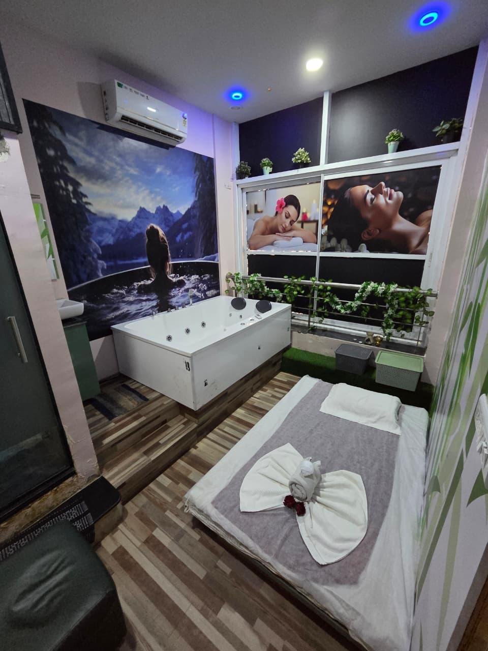 Jacuzzi suite with massage bed setup