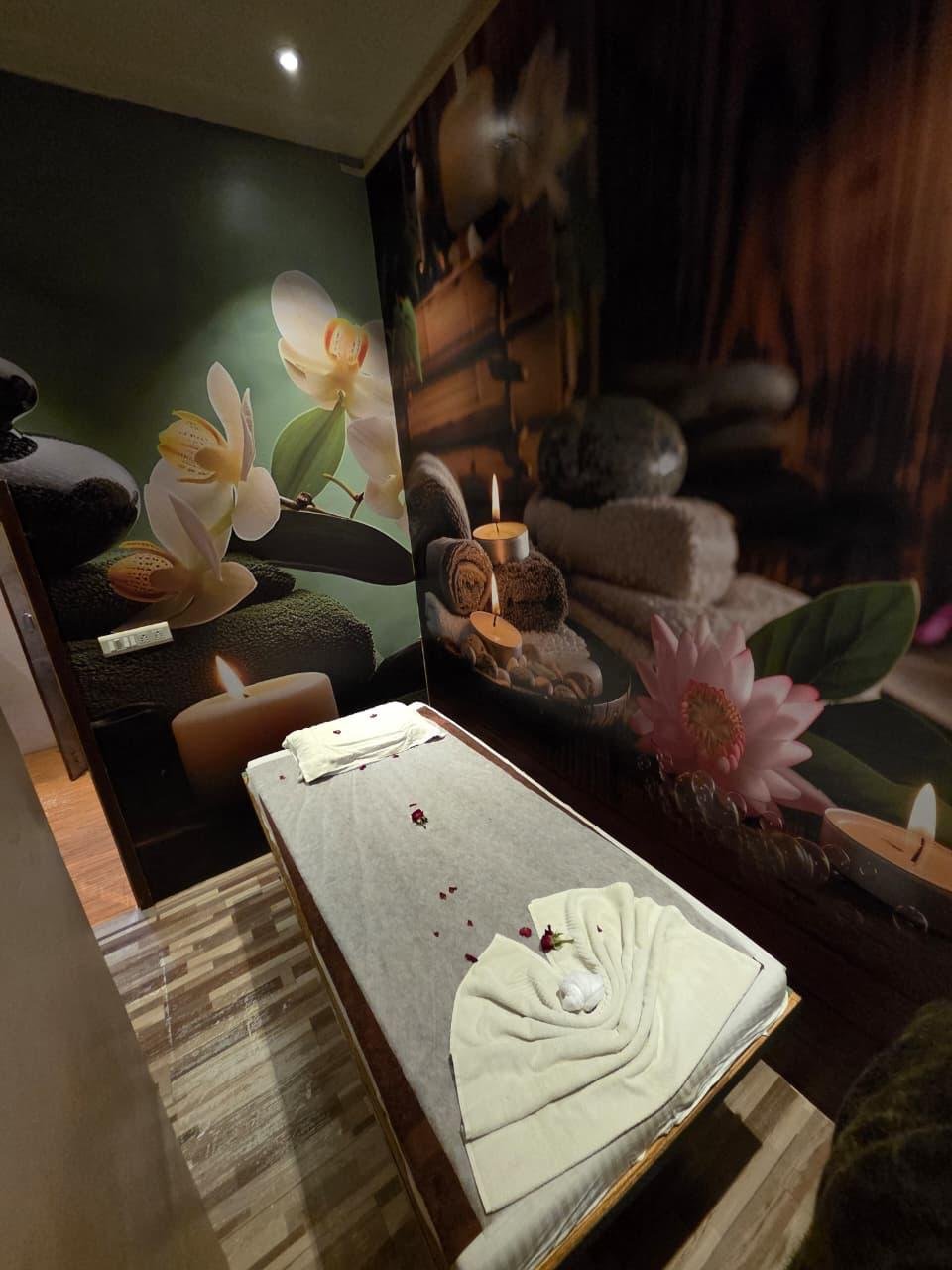 Massage bed with candles and orchid decor